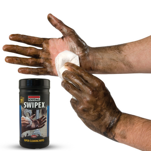 Person cleaning dirty hands with Soudal Swipex wipes on a white background
